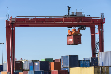 Cargo container hanging on a crane in the Barcelona Harborのeditorial素材