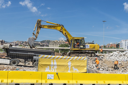 Barcelona, Spain - 28 April, 2014  excavator placing sand or debris on a truck  Pictured are several workersのeditorial素材