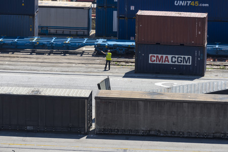 Barcelona, Spain - May 14, 2014: Overview of Container Terminal in the port of Barcelona where there are all kinds of containers and vats. In the picture, a worker directs and organizes container traffic.Container Terminal in the port of Barcelona のeditorial素材