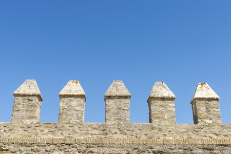 Merlons of an old fortress wall in a sunny day