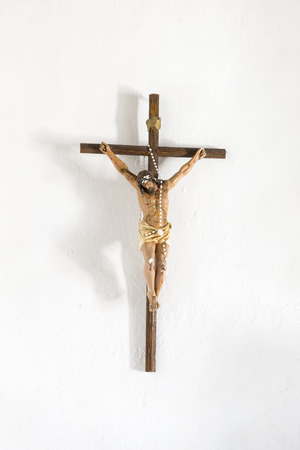Jesus Christ hanging on the cross on a white wallの写真素材