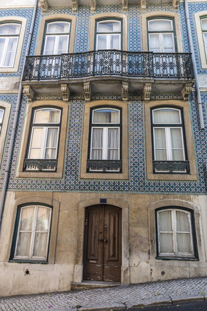 traditional building facade with characteristic balconies in Lisbon, Portugalの写真素材