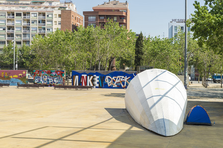 Barcelona, Spain - May 9, 2014: homeless  living in a tent in a park with a wall full of graffiti in Barcelona, Catalonia, Spain.のeditorial素材