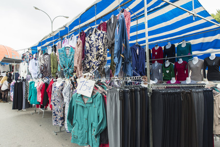 Badalona, Spain - November 1, 2014: Stall clothes in the market Turo Caritg in Badalona, a town next to Barcelona. The vendors serve customers while they choose and seek something you likeのeditorial素材