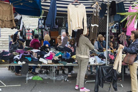 Badalona, Spain - November 1, 2014: Stall clothes in the market Turo Caritg in Badalona, a town next to Barcelona. The vendors serve customers while they choose and seek something you likeのeditorial素材