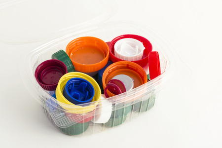 lots of plastic plugs in a plastic container isolated on white backgroundの写真素材