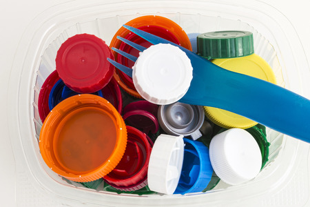 lots of plastic plugs in a plastic container isolated on white backgroundの写真素材
