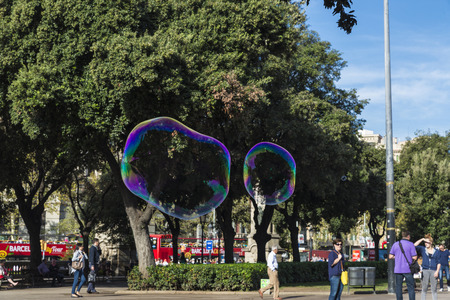 Barcelona, Spain - October 17, 2014: large soap bubbles floating in Placa Catalunya while...