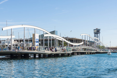 Barcelona, Spain - October 22, 2014: Tourists are strolling on the Marina Port Vell and the Rambla del Mar in Barcelona The Rambla del Mar is a main attraction in Barcelona. Barcelona is a vibrant modern city at the Mediterranean with lots of attractionsのeditorial素材