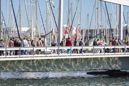 Barcelona, Spain - October 22, 2014: Tourists are strolling on the Marina Port Vell and the Rambla del Mar in Barcelona The Rambla del Mar is a main attraction in Barcelona. Barcelona is a vibrant modern city at the Mediterranean with lots of attractionsのeditorial素材