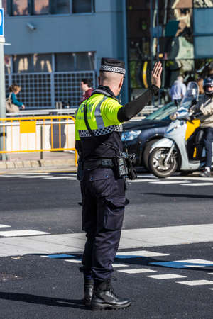 Barcelona, Spain - November 7, 2014: Police directing traffic in a square in Barcelona. This police force is called Guardia Urbana de Barcelona and one of its functions is to control the traffic in the cityのeditorial素材