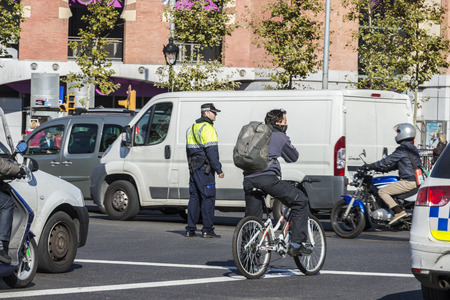 Barcelona, Spain - November 7, 2014: Police directing traffic in a square in Barcelona. This police force is called Guardia Urbana de Barcelona and one of its functions is to control the traffic in the cityのeditorial素材