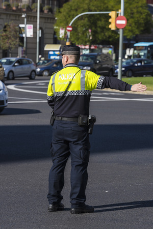 Barcelona, Spain - November 7, 2014: Police directing traffic in a square in Barcelona. This police force is called Guardia Urbana de Barcelona and one of its functions is to control the traffic in the cityのeditorial素材