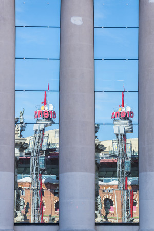 Barcelona, Spain - November 7, 2014: Reflection of Arenas shopping center with its spectacular lift in Spain Square. The mall opened in 2011, was a bullring until 1977のeditorial素材