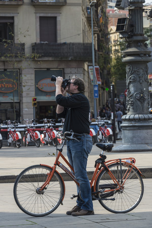Barcelona, Spain - October 29, 2014: Cyclist standing on a walk taking a photographのeditorial素材