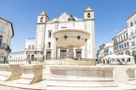 Evora, Portugal - August 21, 2014: Giraldo Square in center of Evora. The square dates from 1570 and features the Renaissance fountain (fonte Henriquina) and the St Anton Church. In this square many terraces of bars where people having a drink in the shadのeditorial素材