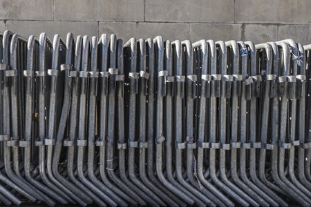 traffic fences placed in a row on a sidewalk
