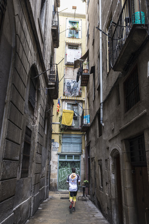 Barcelona, Spain - November 2, 2014: A man practices jogging down a street of the old town of Barcelonaのeditorial素材