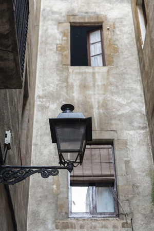 Detail of an old town street with a lamp post in foreground, Barcelona, Catalonia, Spainの写真素材