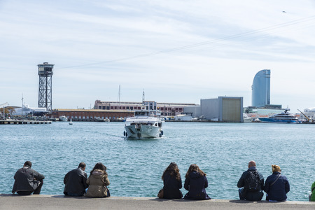 Barcelona, Spain - March 24, 2014: A typical boat to visit the coast of Barcelona for a while called Swallows in the harbor of Barcelona called Port Vell. People take advantage of good weather to sunbathe and relaxのeditorial素材