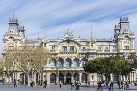 Barcelona, Spain - March 24, 2014: Old office building Barcelona port surrounded by touristsのeditorial素材