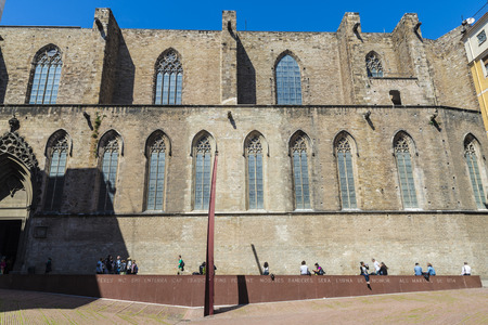 Barcelona, Spain - April 7, 2014: Side facade of the church of Santa Maria del Mar with Fossar de les Moreres in foreground. This place is an old cemetery where they were buried many defenders of the city during the siege suffered by the city in 1713-1714のeditorial素材