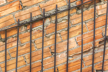 old brick wall with a gate attached to thisの写真素材