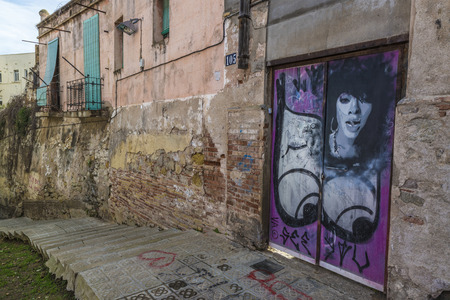 Barcelona, Spain - April 4, 2014: Door covered with graffiti in the old town of Barcelona, Catalonia, Spainのeditorial素材