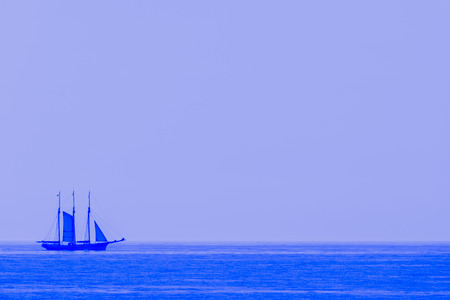Old sailboat sailing on a calm seaの写真素材