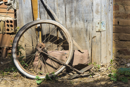 Old abandoned bicycle wheel in a cottageの写真素材