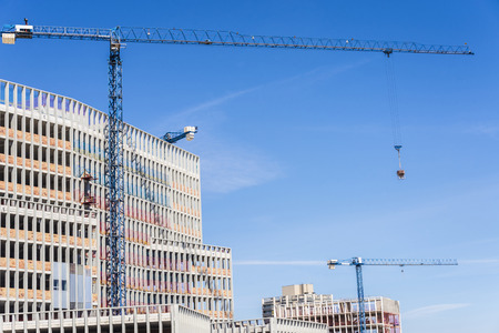 Building under construction and three cranes in Barcelona, Catalonia, Spainの写真素材
