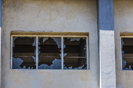 Broken glass on a wall abandoned factory