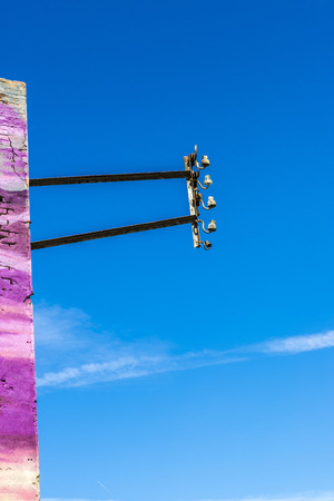 Electricity pole attached to a purple wallの写真素材