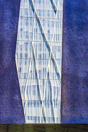 Skyscrapers reflected in the mirrors of a lilac wallの写真素材