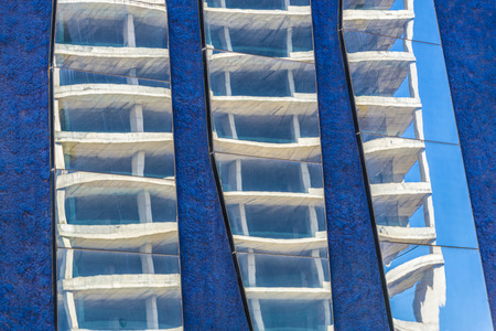 Skyscraper in construction reflected in the mirrors of a lilac wallの写真素材