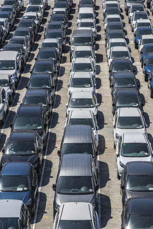 New cars parked in a row in the port of Barcelona, Catalonia, Spain. They are waiting to be shipped.の写真素材