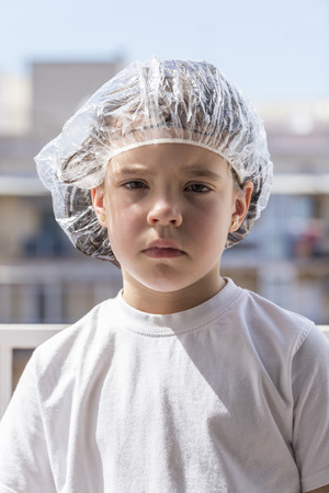 Little girl in a bathing cap following a antilice treatmentの写真素材