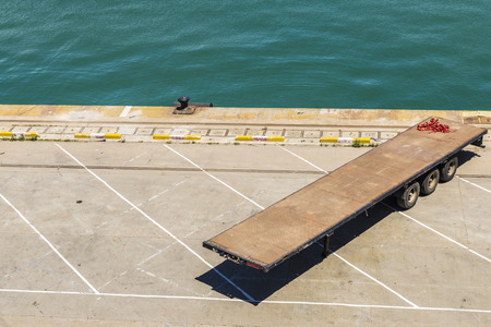 Empty trailer parked in an empty dockの写真素材