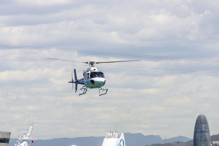 Barcelona, Spain - May 23, 2014: Helicopter flying with the Agbar tower in the backgroundのeditorial素材