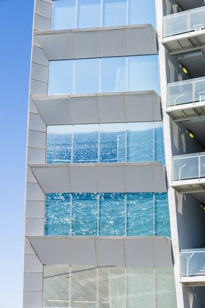 Sea reflected on a window of a modern building in Barcelona, Catalonia, Spainの写真素材