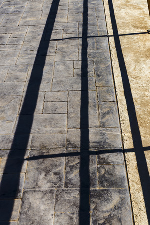 Stone floor with shadows of a railingの写真素材