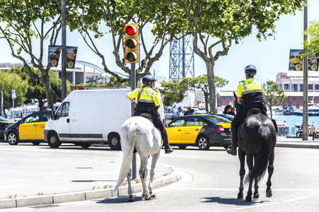 Barcelona, Spain - April 21, 2015: City police on horseback in Ramblas. This police force is called Guardia Urbana de Barcelona and one of its functions is to control the traffic in the cityのeditorial素材
