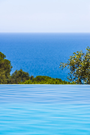 Landscape with sea views from an outdoor pool in Costa Brava, Catalonia, Spainの写真素材