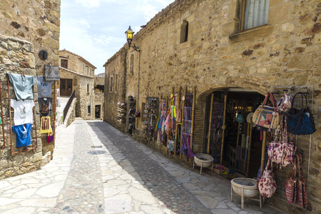 Pals, Girona, Spain - July 3, 2015: Souvenir shop and clothing in the medieval town of Pals.のeditorial素材