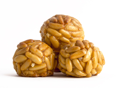Panellet pine nuts isolated on white. Panellet are traditional desserts of All Saints holiday, known as Castanyada in Catalonia, Spainの写真素材