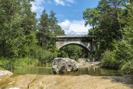 Barcelona, Spain - August 22, 2015: River with bathing area in Puigcercos, Catalonia. A family is on vacation with children playing and bathingのeditorial素材