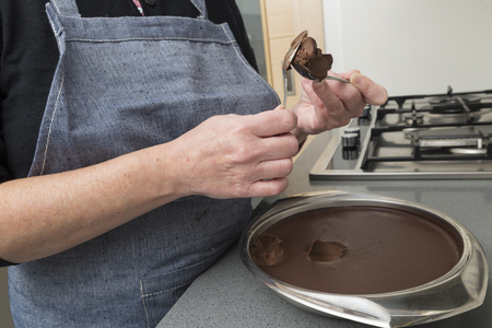 Woman preparing chocolate truffles in the kitchenの写真素材