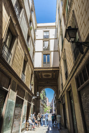 Barcelona, Spain - June 4, 2015: Passage of the oldest district called Passatge de la Pau of Barcelona with people walking around and taking a drink in Catalonia, Spainのeditorial素材