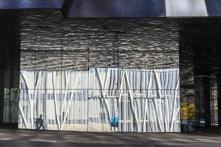 Two people and buildings reflected in the glass producing abstract effects in Barcelona, Catalonia, Spainの写真素材