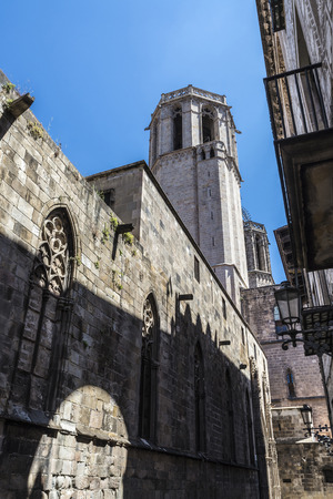 Street of the Gothic Quarter, which include the bell tower of the Cathedral of Barcelona in Catalonia, Spainの写真素材